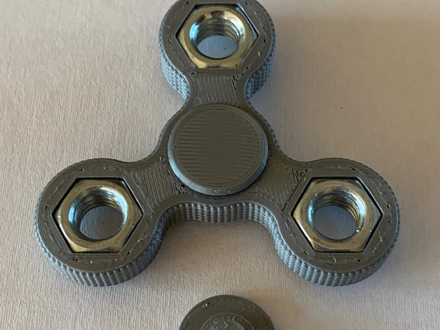 3D-printed fidget spinner with hex nut weights